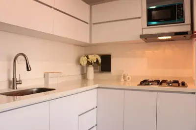 a kitchen with white cabinets and a sink at Moderno Apartamento al Norte de Barranquilla in Barranquilla