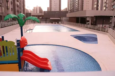 two swimming pools in a building with buildings at Moderno Apartamento al Norte de Barranquilla in Barranquilla