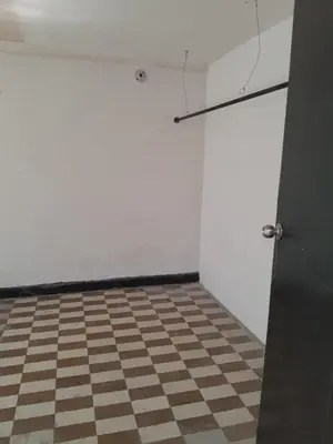 a room with a checkered floor and a white wall at BAQ central point in Barranquilla