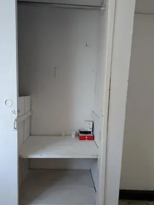 a white closet with a shelf with a clock on it at BAQ central point in Barranquilla