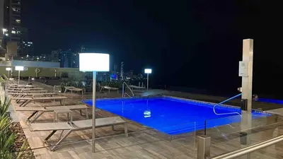 a swimming pool on top of a building at night at Luxury apt sea front AC Wifi pool at cartagena in Cartagena de Indias