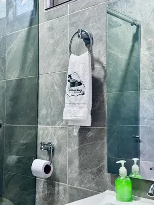 a bathroom with a sink and a towel on a mirror at Cabaña La Roca in San Antero