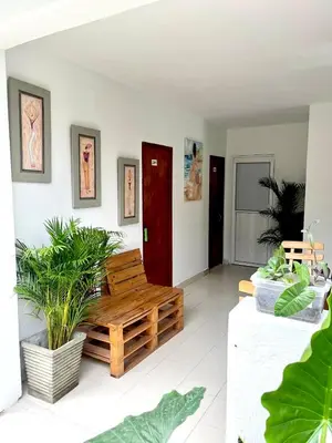 a living room with a wooden bench and plants at Habitación cerca de la playa 204 in Cartagena de Indias