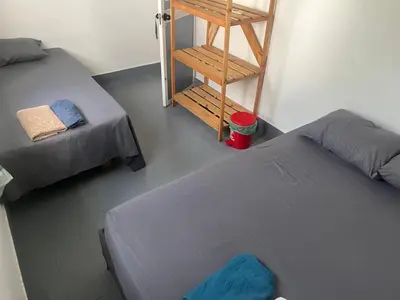 a room with two beds and a ladder and a staircase at Habitación cerca de la playa 204 in Cartagena de Indias