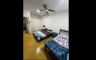 a bedroom with two beds and a ceiling fan at Cabaña Mery frente al mar in San Antero