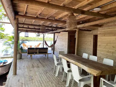 an outdoor dining room with a wooden table and chairs at Prueba1 in Tintipan Island