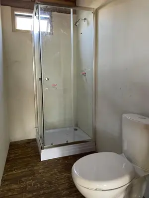a bathroom with a toilet and a glass shower at Prueba1 in Tintipan Island