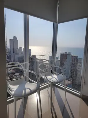 two white chairs sitting on top of a window at Apartamento Magnoloft Bocagrande in Cartagena de Indias