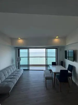 a living room with a couch and a table and chairs at Amazing Bay View Apartment in Cartagena! in Cartagena de Indias