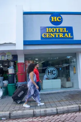 a man and a woman walking in front of a hotel terminal at Hotel Central in Sincelejo