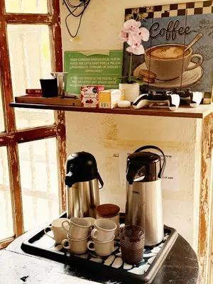 a coffee pot and cups on top of a stove at Pachamama Hostel in Cartagena de Indias