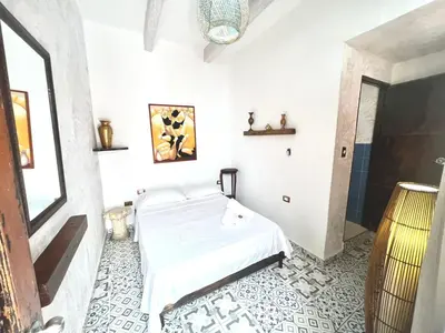 a white bedroom with a bed in a room at Pachamama Hostel in Cartagena de Indias