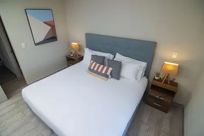 a bedroom with a large white bed with pillows at New & Comfortable Apartment In Cielo Mar in Cartagena de Indias