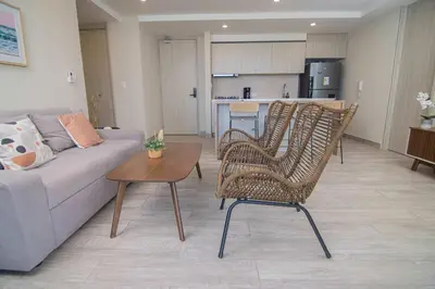 a living room with a couch and chairs and a table at New & Comfortable Apartment In Cielo Mar in Cartagena de Indias