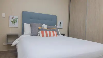 a large white bed with pillows on top of it at New & Comfortable Apartment In Cielo Mar in Cartagena de Indias