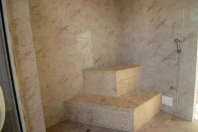 a walk in shower with two stone steps in a bathroom at New & Comfortable Apartment In Cielo Mar in Cartagena de Indias