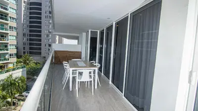 a balcony with a table and chairs on it at New & Comfortable Apartment In Cielo Mar in Cartagena de Indias