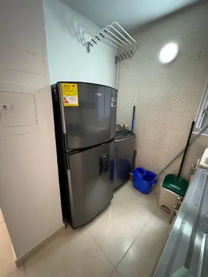 a kitchen with a refrigerator in a room at Apartamento norte de Barranquilla in Barranquilla