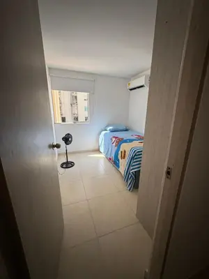 a small bedroom with a bed and a window at Apartamento norte de Barranquilla in Barranquilla