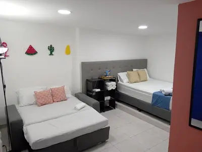 a room with two beds and a couch at Comfy apartment in historic center in Cartagena de Indias