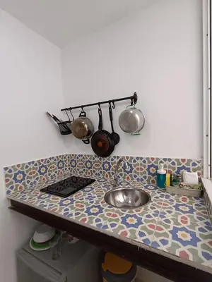 a kitchen counter with a sink and pots and pans at Comfy apartment in historic center in Cartagena de Indias