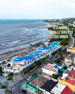 an aerial view of a beach with blue umbrellas at Low cost 2A,TV 60 15 min B vista in Barranquilla