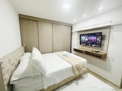 a bedroom with a bed and a flat screen tv at Low cost 2A,TV 60 15 min B vista in Barranquilla