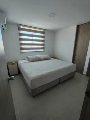 a bedroom with a large bed with a window at Hermoso apartamento in Cartagena de Indias