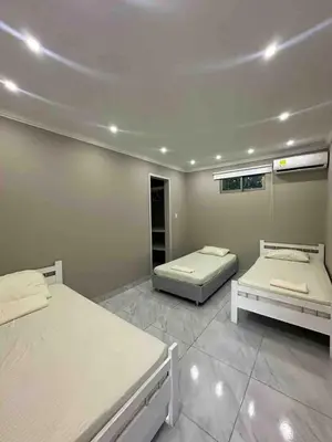 a bedroom with two beds in a room at Villa Maty Casa Campestre in Turbaco