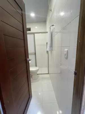 a bathroom with a toilet and a shower and a door at Apartamento Salome Coveñas in Coveñas