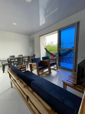 a living room with a couch and a large window at Apartamento Salome Coveñas in Coveñas