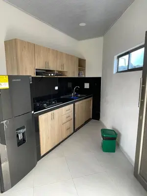 a kitchen with wooden cabinets and a sink at Apartamento Salome Coveñas in Coveñas