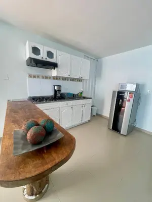 a kitchen with a wooden counter top in a room at Apartamentos cerca al hotel Las Americas in Cartagena de Indias