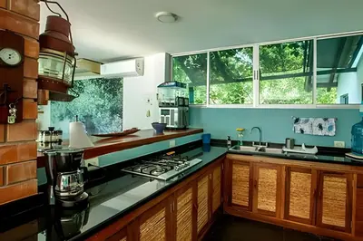 a kitchen with a sink and a stove top oven at Casa de playa Manglares in Tolú
