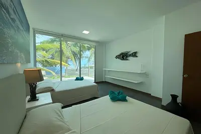 a bedroom with two beds and a window at Casa de playa Manglares in Tolú