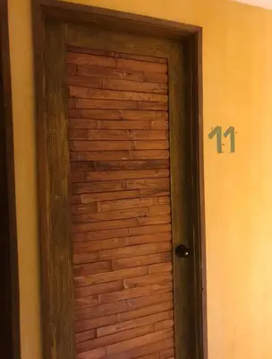 a wooden door with the number on it at Hostal Bambumar in Cartagena de Indias