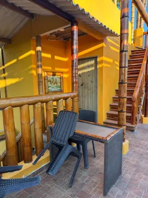 a bench sitting on the porch of a house at Hostal Bambumar in Cartagena de Indias
