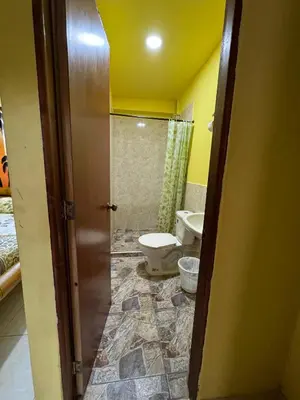 a bathroom with a toilet and a sink at Hostal Bambumar in Cartagena de Indias
