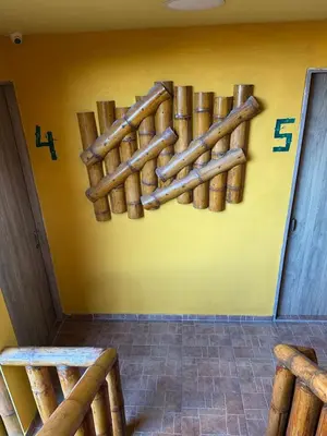 a wall with a bunch of logs on it at Hostal Bambumar in Cartagena de Indias
