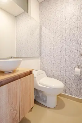 a bathroom with a white toilet and a sink at Paraíso Costero Apartamento de Lujo con Vista Directa al Mar in Cartagena de Indias