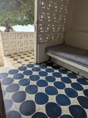 a porch with a bench on a tiled floor at Casa en el Mar in San Onofre
