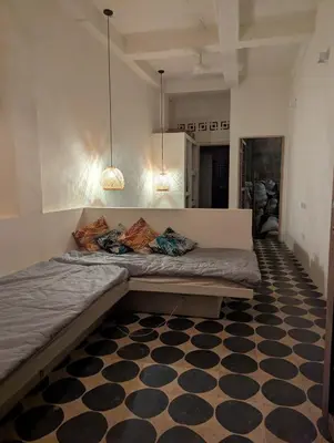 a bed in a room with a black and white floor at Casa en el Mar in San Onofre