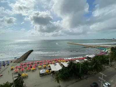 a view of a beach with umbrellas and the ocean at Apartamento Palmetto Eliptic ICDI in Cartagena de Indias