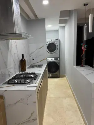 a kitchen with a stove and a washing machine at Apartamento 2 habitaciones zona Riomar Barranquilla in Barranquilla