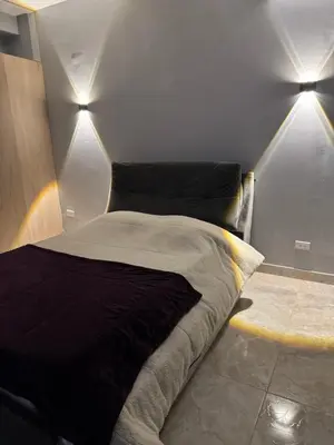 a bed in a room with two lights on it at Apartamento 2 habitaciones zona Riomar Barranquilla in Barranquilla