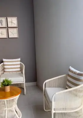 a living room with two chairs and a table at Apartamento de lujo para estrenar en Morros Cartagena in Cartagena de Indias