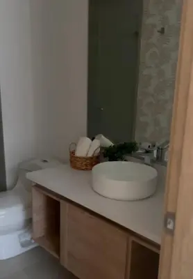 a bathroom with a sink and a toilet and a mirror at Apartamento de lujo para estrenar en Morros Cartagena in Cartagena de Indias