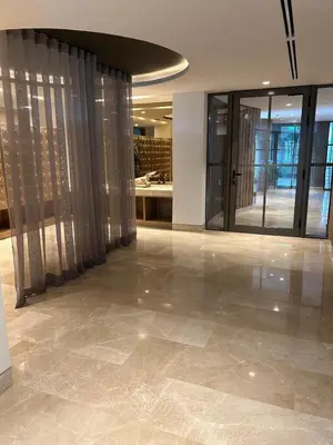 a lobby with glass doors and a tile floor at Apartamento de lujo para estrenar en Morros Cartagena in Cartagena de Indias