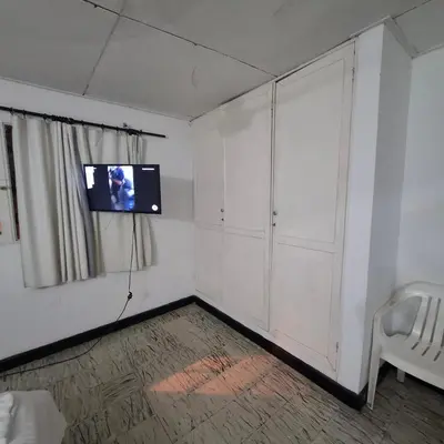 a room with a flat screen tv on the wall at Habitación Girasoles in Cartagena de Indias