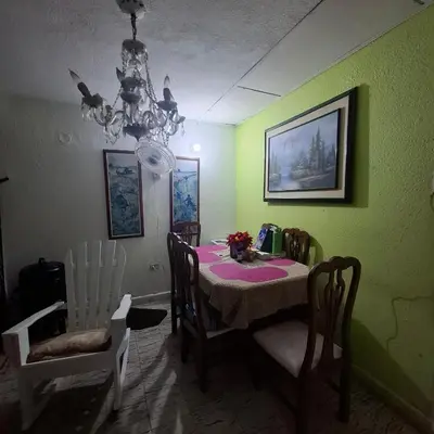 a dining room with a table and chairs and a chandelier at Habitación Girasoles in Cartagena de Indias